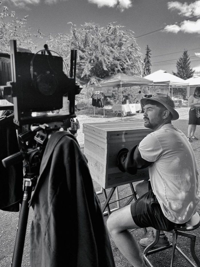 The photographer reaching into the portable developing box