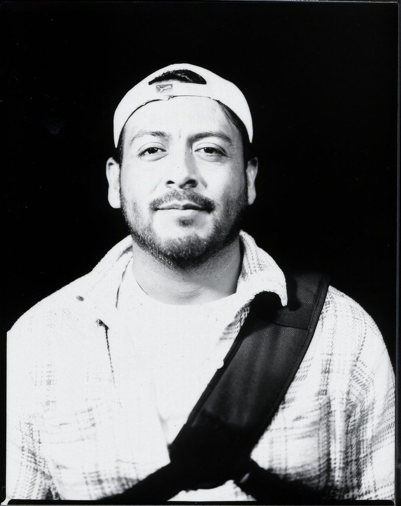 Black-and-white large format portrait of a man in a backward cap, made at Seattle Outdoor Dance